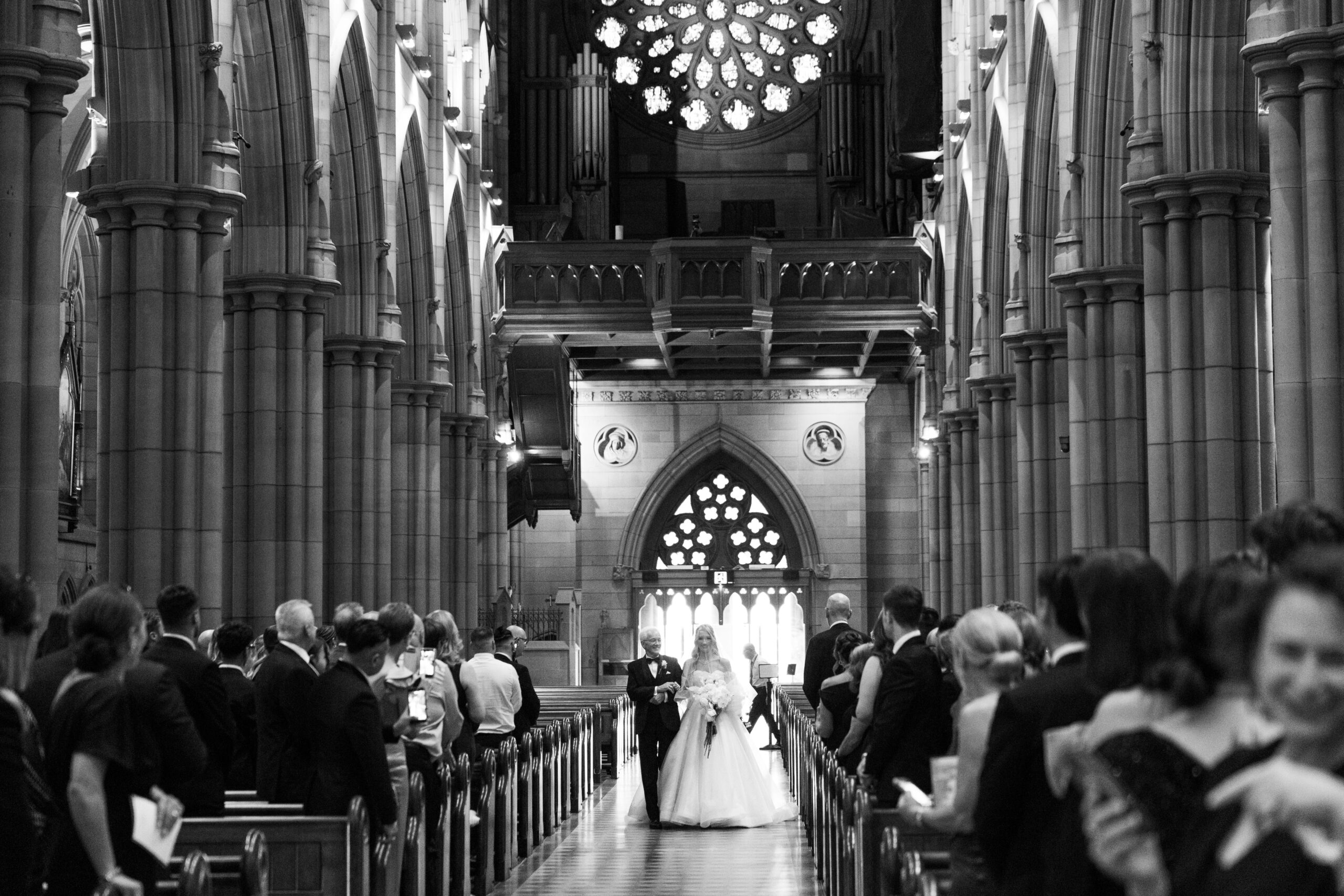 Alexandra walking down the aisle with her father at St Mary's Cathedral